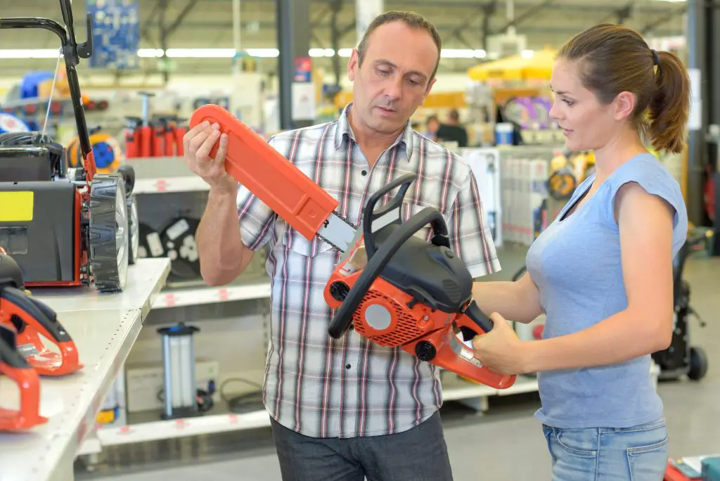 woman with chainsaw in hardware store